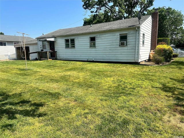 rear view of house featuring a lawn