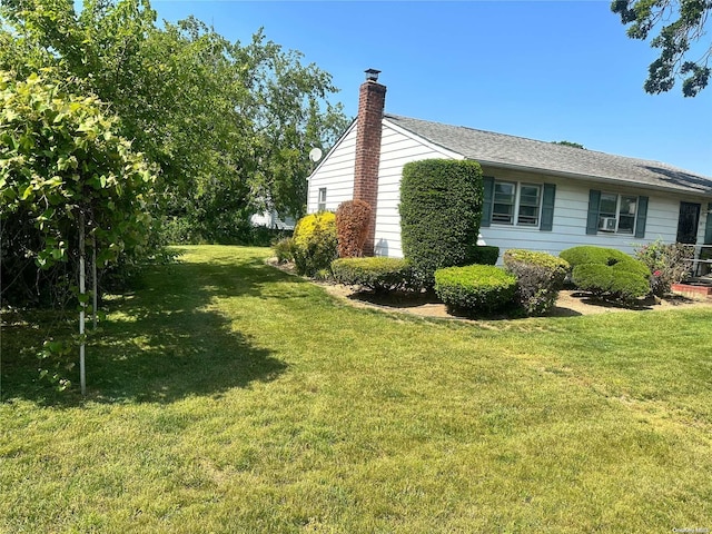 view of side of property with a lawn