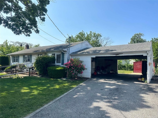 ranch-style home with a carport and a front lawn