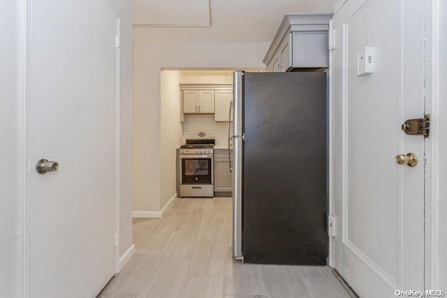 kitchen with appliances with stainless steel finishes and backsplash