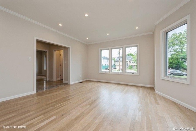 unfurnished room with ornamental molding, light hardwood / wood-style flooring, and a healthy amount of sunlight