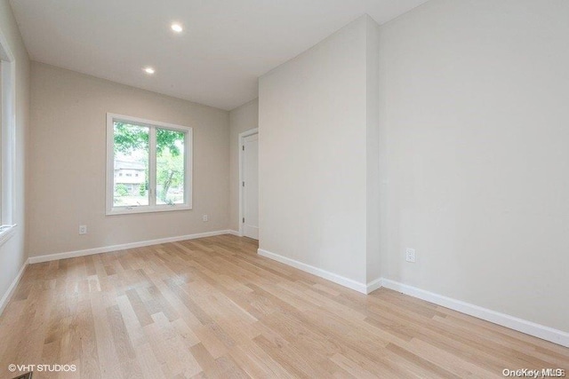 empty room with light hardwood / wood-style flooring