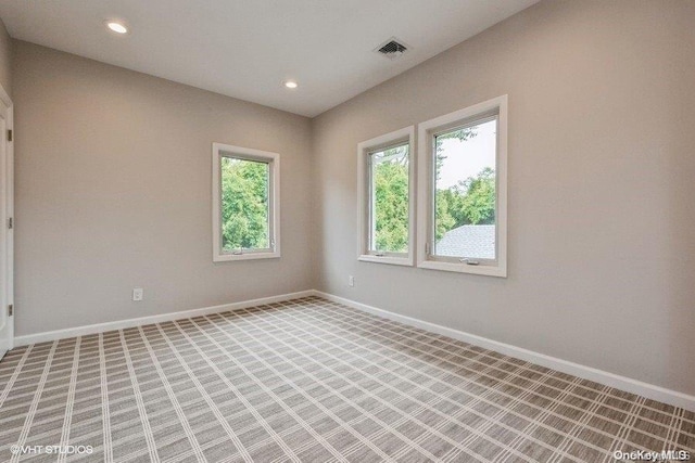 empty room featuring light carpet and a healthy amount of sunlight