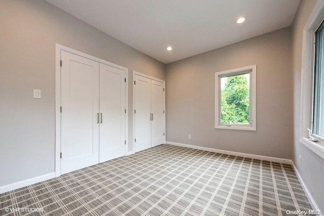 unfurnished bedroom with light colored carpet