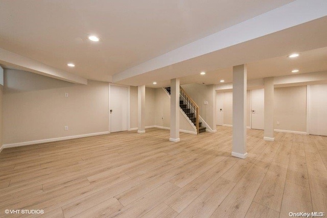 basement with light hardwood / wood-style floors