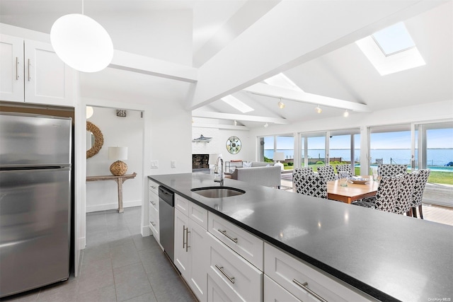 kitchen with sink, white cabinets, stainless steel appliances, and plenty of natural light