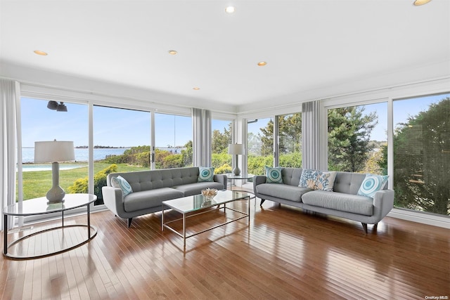 sunroom featuring a wealth of natural light and a water view