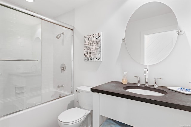 full bathroom with vanity, toilet, and bath / shower combo with glass door