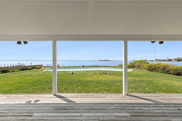 deck with a yard and a water view