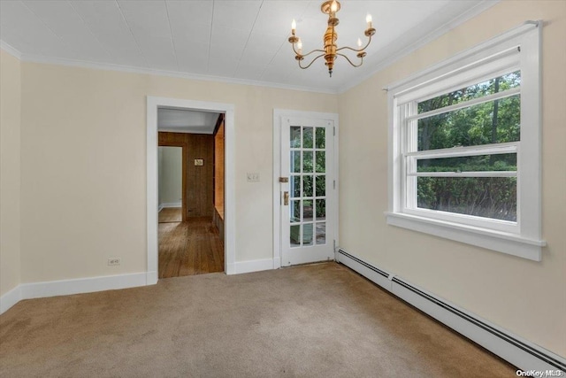 carpeted empty room with baseboard heating, crown molding, and an inviting chandelier