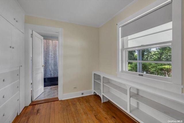 interior space featuring hardwood / wood-style flooring and crown molding