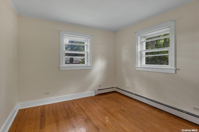 empty room featuring light hardwood / wood-style floors and baseboard heating