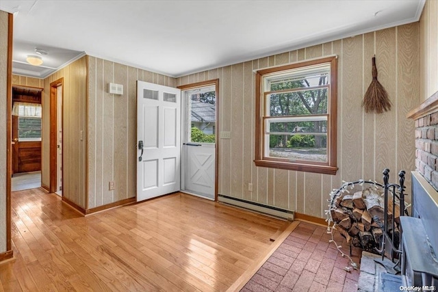 foyer entrance with baseboard heating and light hardwood / wood-style flooring