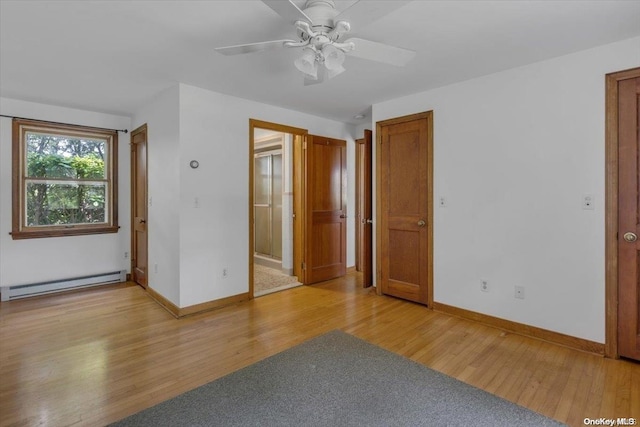 unfurnished room with ceiling fan, a baseboard heating unit, and light wood-type flooring