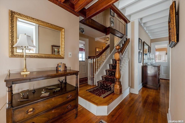 entrance foyer featuring beam ceiling and dark hardwood / wood-style floors