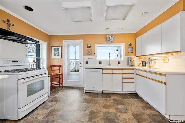 kitchen with a wealth of natural light, sink, white cabinets, and white appliances