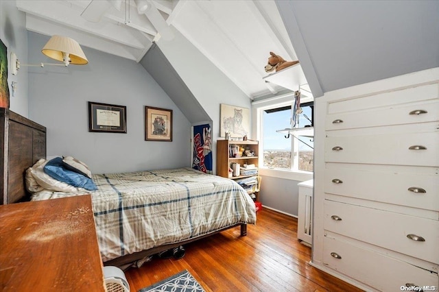 bedroom with hardwood / wood-style floors, lofted ceiling with beams, and ceiling fan