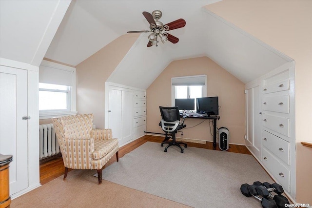 office with light hardwood / wood-style flooring, radiator, and lofted ceiling