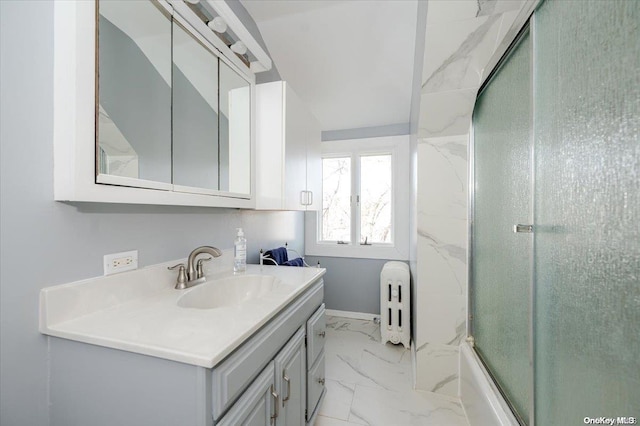 bathroom with radiator heating unit, vanity, and bath / shower combo with glass door