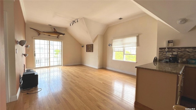 living room with light hardwood / wood-style floors, lofted ceiling, and crown molding