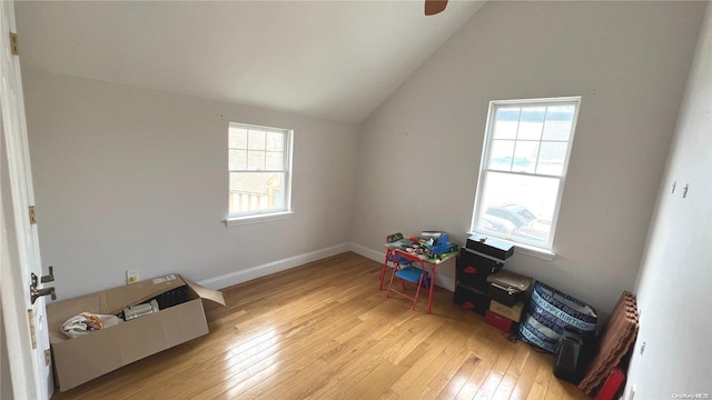 recreation room featuring vaulted ceiling, light hardwood / wood-style flooring, and a wealth of natural light