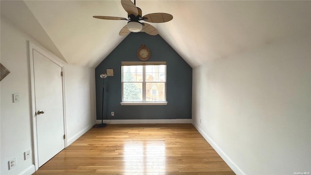 additional living space with ceiling fan, light wood-type flooring, and lofted ceiling