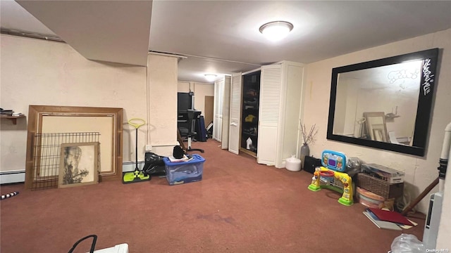 basement featuring a baseboard radiator and dark carpet