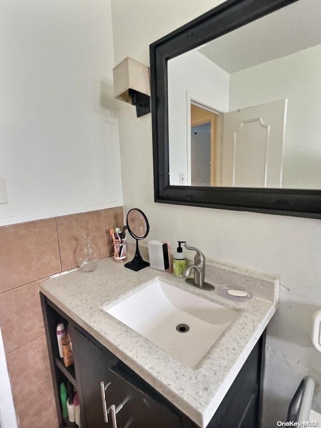 bathroom featuring vanity and tasteful backsplash