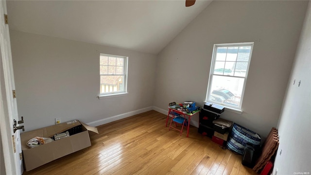 game room featuring light hardwood / wood-style flooring, a healthy amount of sunlight, and vaulted ceiling