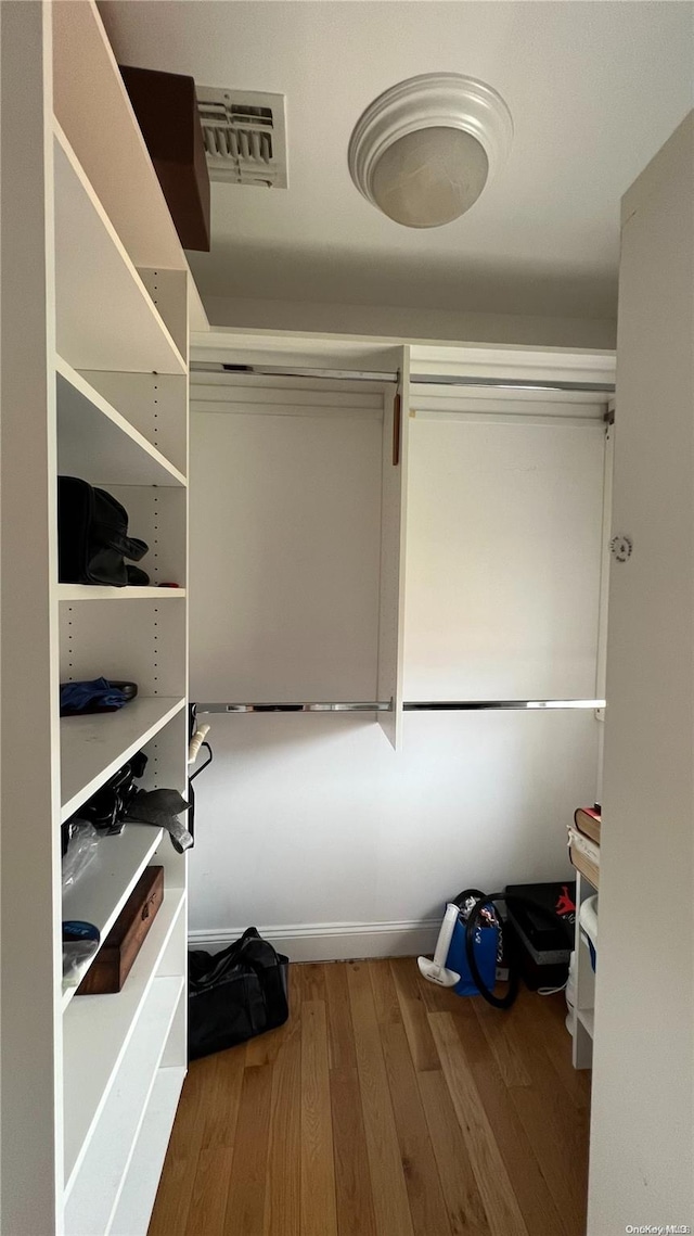 spacious closet featuring hardwood / wood-style floors