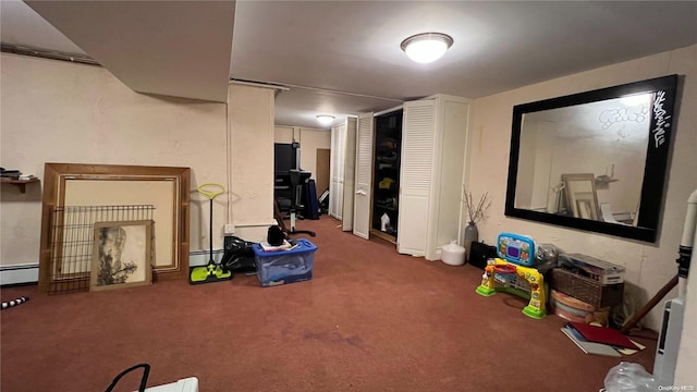 basement with dark colored carpet and baseboard heating