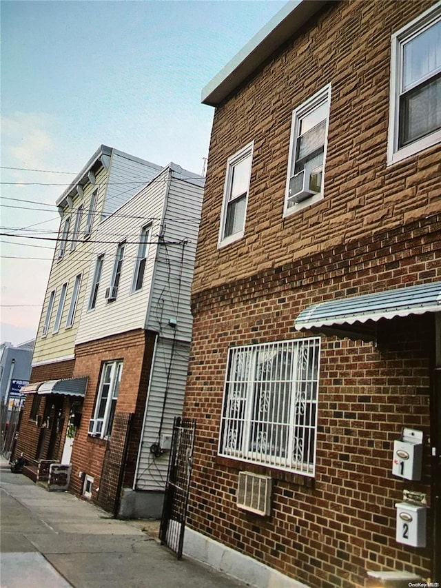 property exterior at dusk with cooling unit