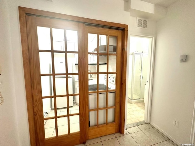 entryway with french doors and light tile patterned floors