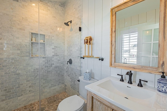 bathroom featuring vanity, toilet, and walk in shower