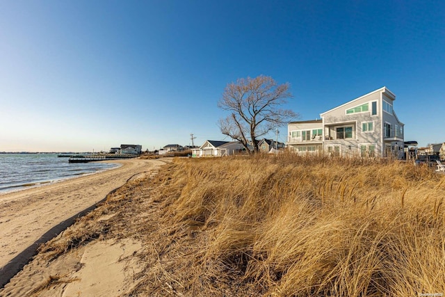 exterior space with a beach view and a water view