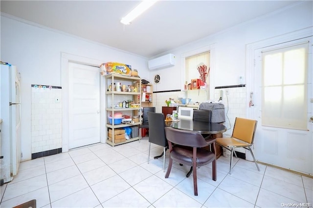 tiled dining room featuring crown molding, tile walls, and a wall mounted AC