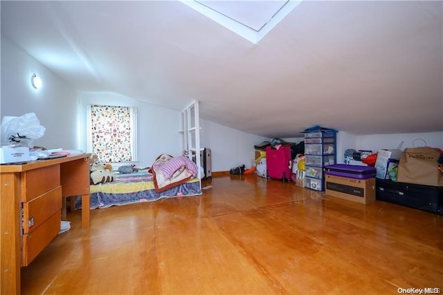 additional living space featuring hardwood / wood-style floors and vaulted ceiling