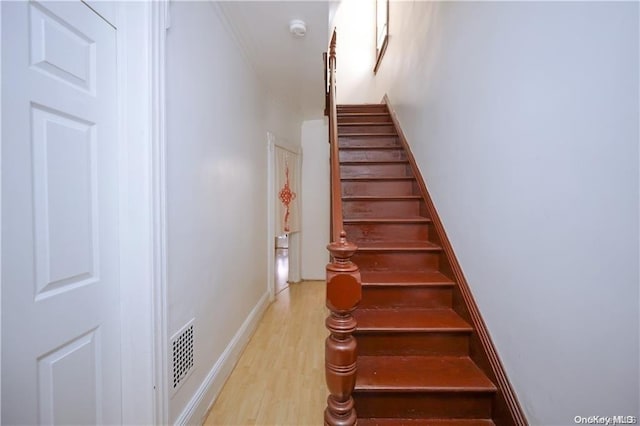 staircase with hardwood / wood-style floors