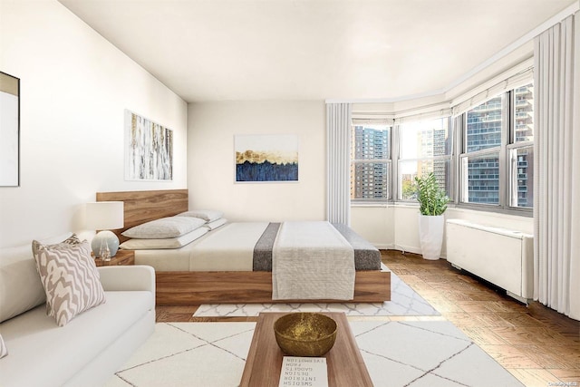 bedroom with radiator heating unit and parquet floors