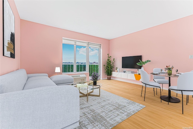 living room featuring a wall mounted air conditioner and hardwood / wood-style floors