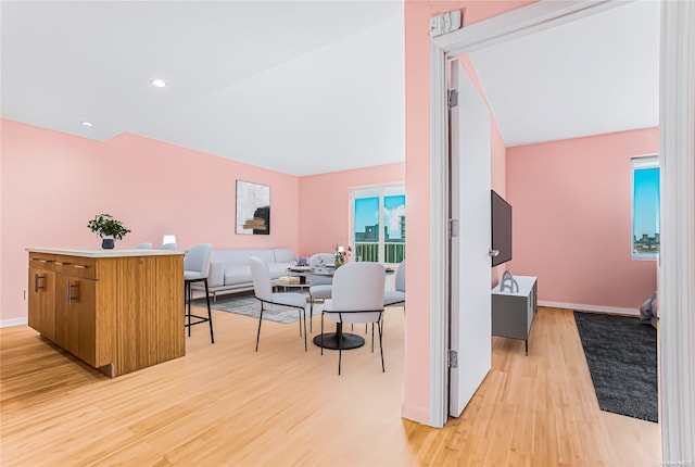 interior space featuring lofted ceiling and light wood-type flooring