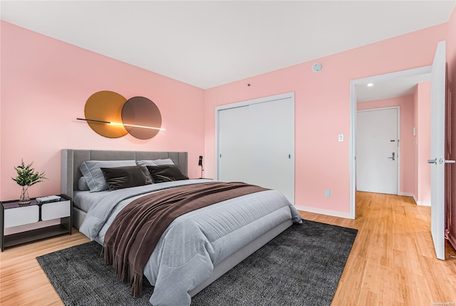 bedroom featuring wood-type flooring and a closet