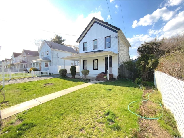 view of front of property with covered porch and a front yard