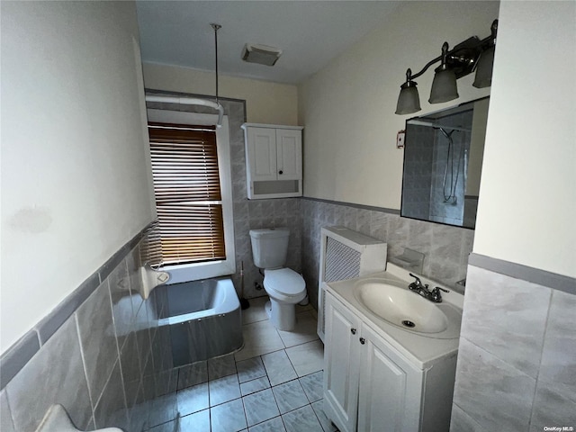 bathroom with walk in shower, vanity, tile walls, tile patterned flooring, and toilet