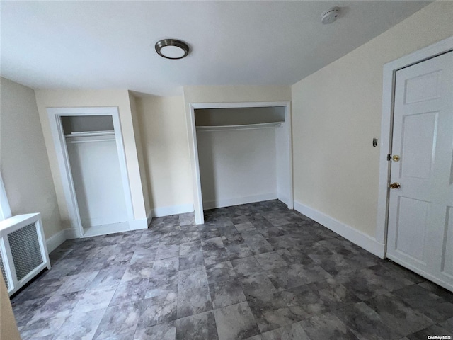 unfurnished bedroom featuring two closets