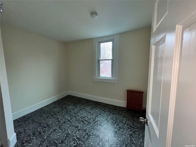 spare room featuring radiator heating unit