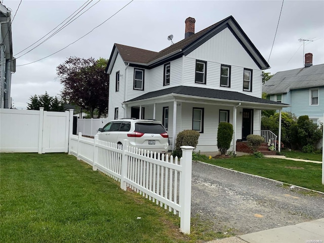 view of front of home with a front yard and covered porch