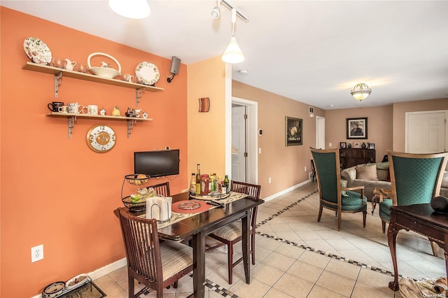 dining space featuring light tile patterned floors