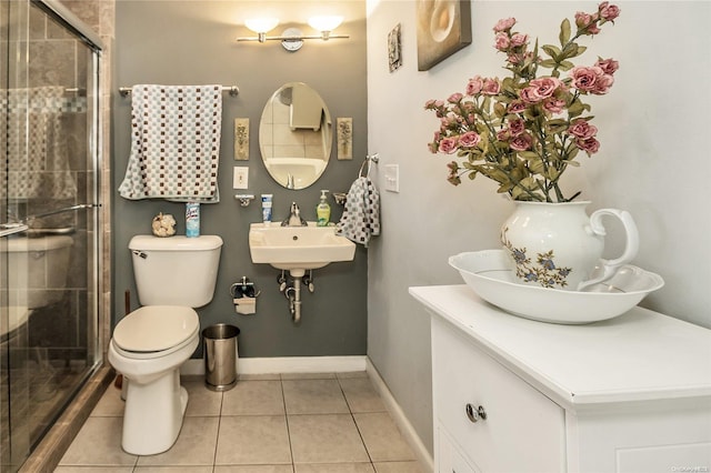 bathroom featuring walk in shower, sink, tile patterned flooring, and toilet