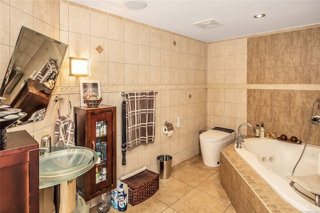 bathroom featuring toilet, tile patterned floors, tile walls, and tiled tub